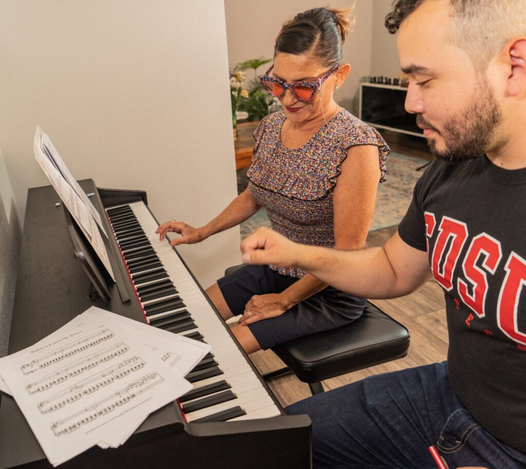 Mr.Jose teaching adult woman piano