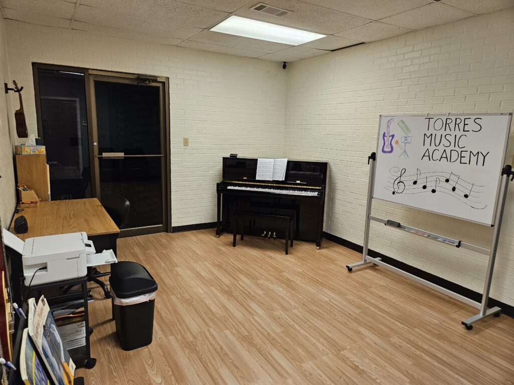 Piano and whiteboard Torres Music Academy music studio in Plano, TX