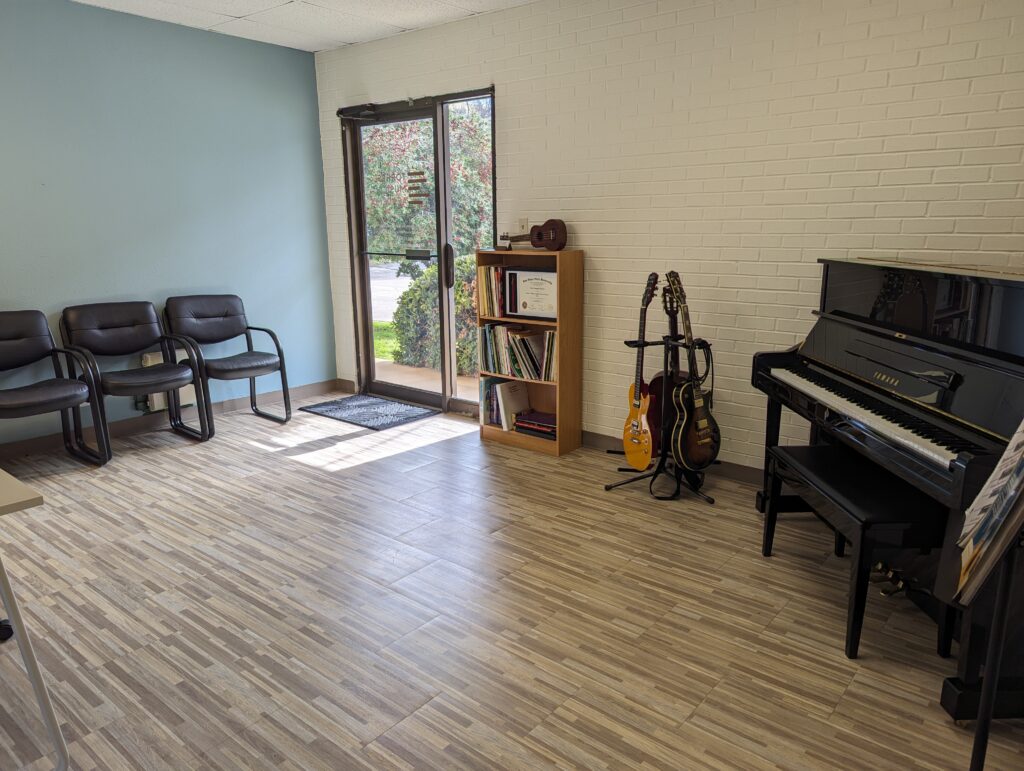 Piano, guitars, and books at Torres Music Academy music studio in Plano, TX