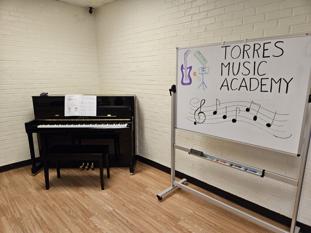 Piano and whiteboard at Torres Music Academy music studio in Plano, TX