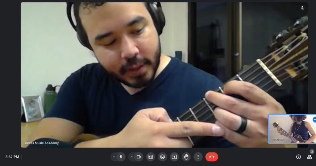 Torres Music Academy guitar instructor giving an online guitar lesson.