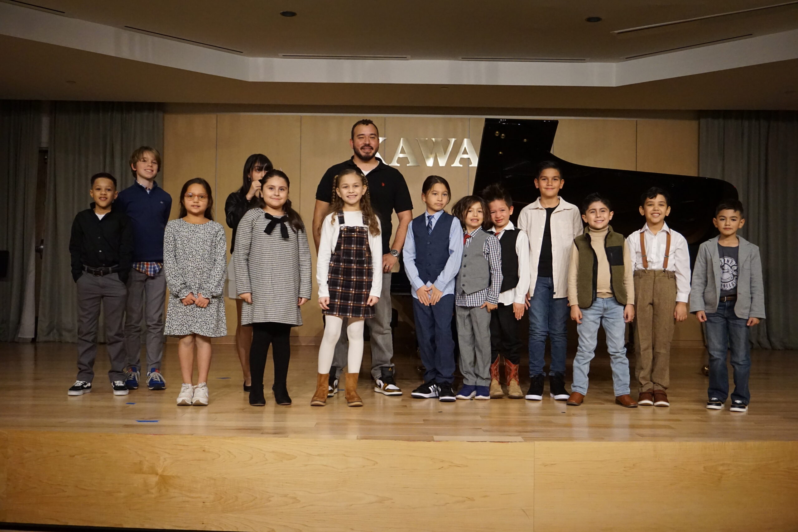 Jose Torres Music Teacher at Torres Music Academy with students during music recital